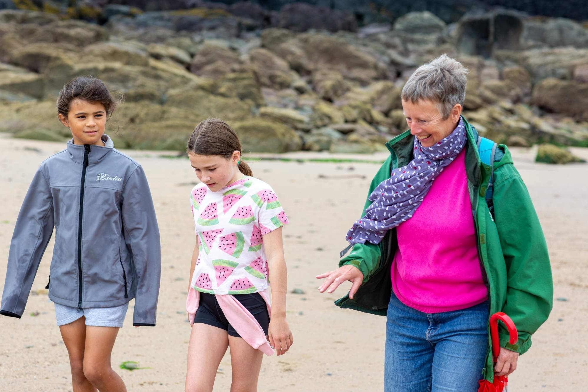 Mum and two daughters walking on the beach