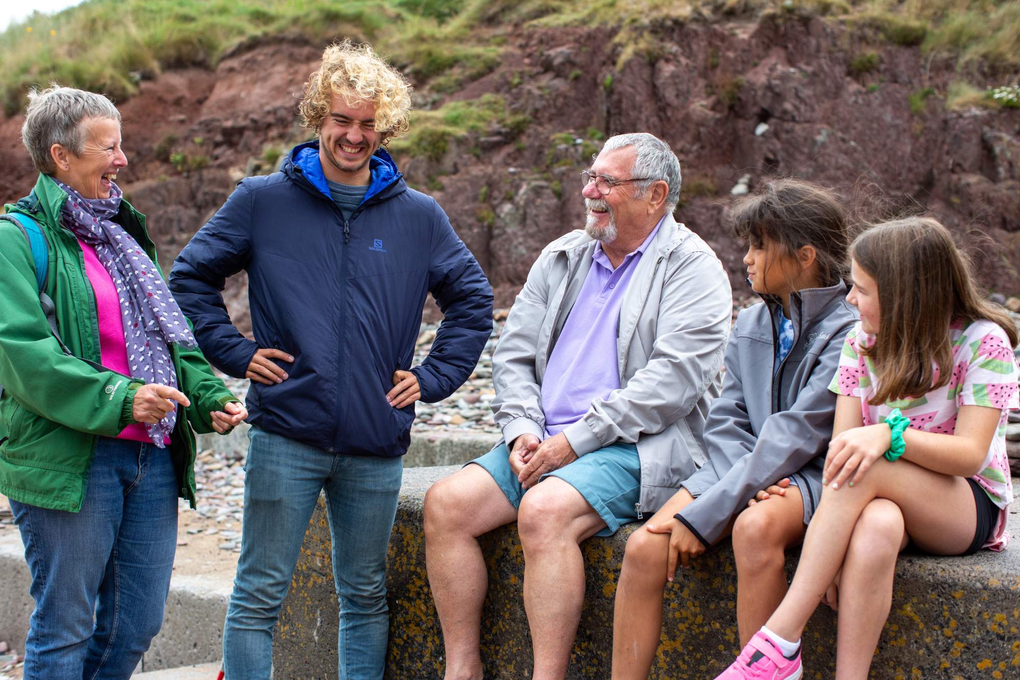 A family laughing together on the beach