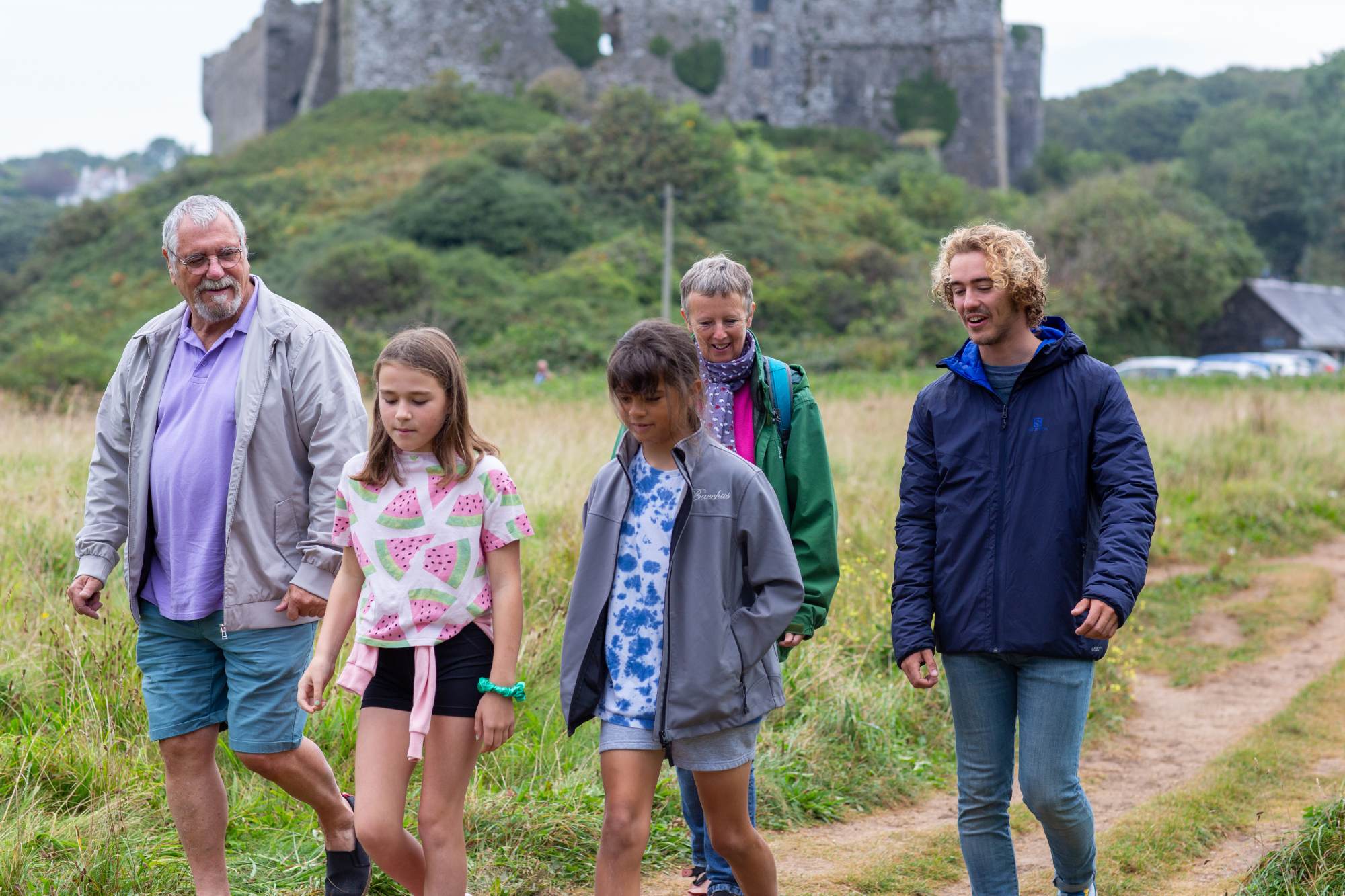 A family walking with a castle in the background
