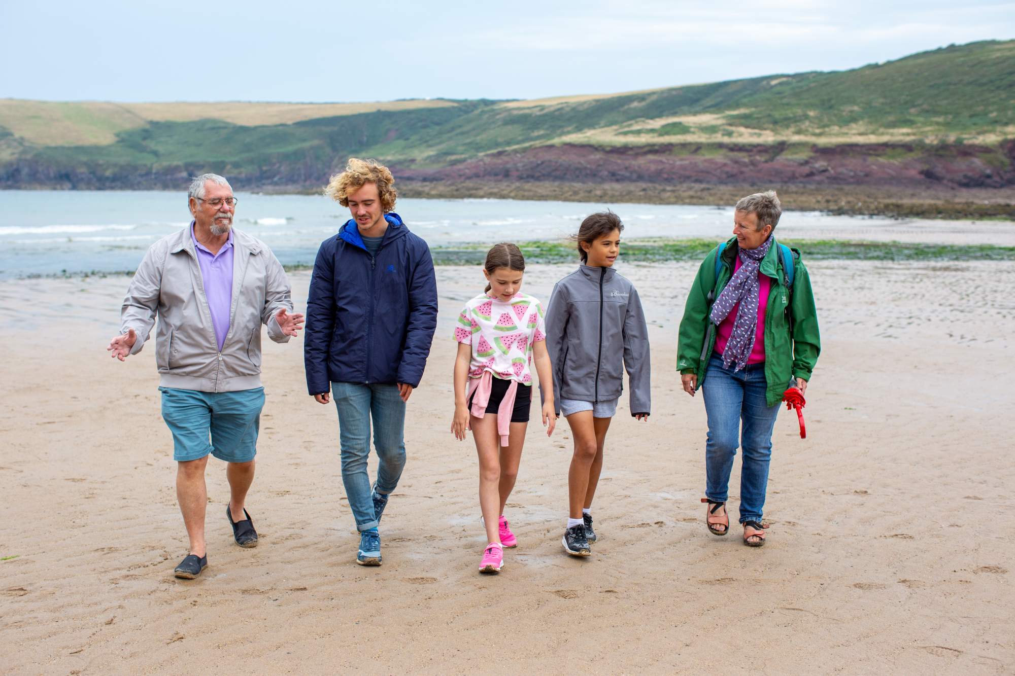 A family walking on the beach in Pembrokeshire